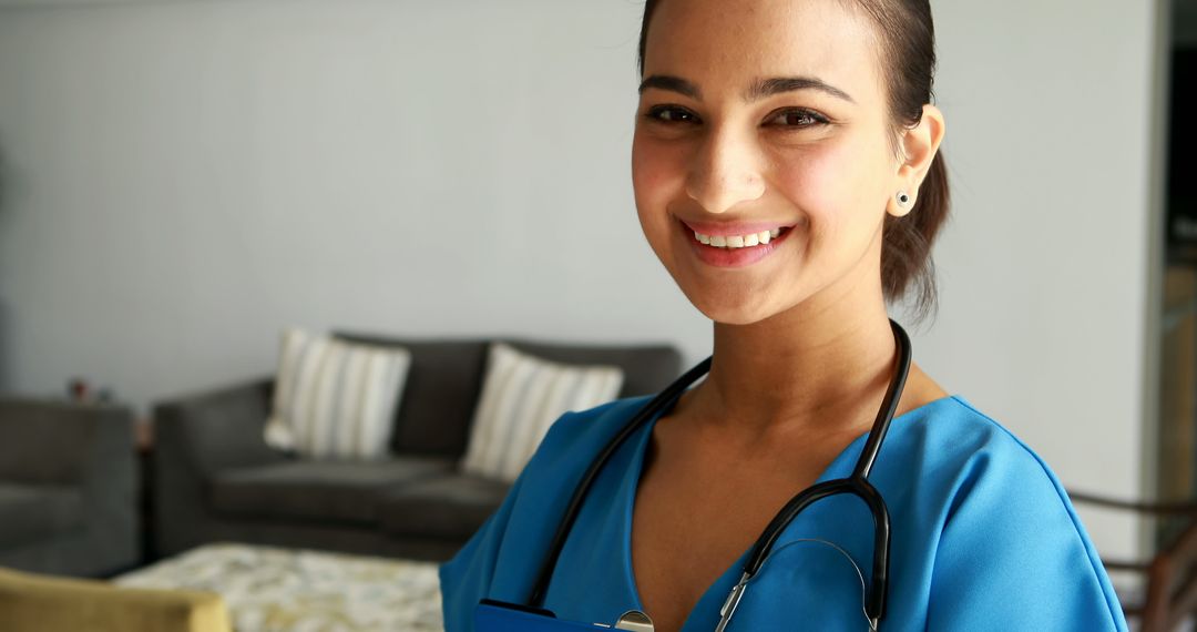 Smiling Female Healthcare Professional with Stethoscope at Home - Free Images, Stock Photos and Pictures on Pikwizard.com