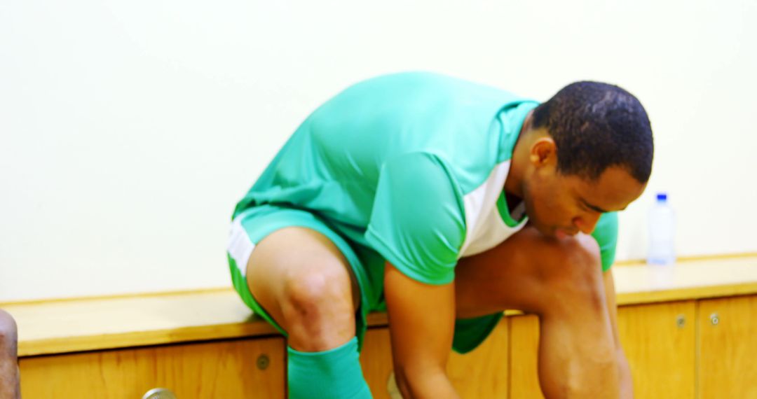 Soccer Player Tying Shoelaces in Locker Room - Free Images, Stock Photos and Pictures on Pikwizard.com