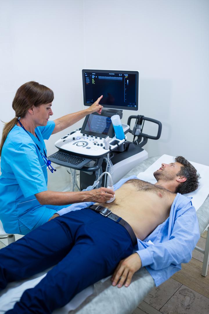 Man getting ultrasound of a abdomen from doctor - Free Images, Stock Photos and Pictures on Pikwizard.com