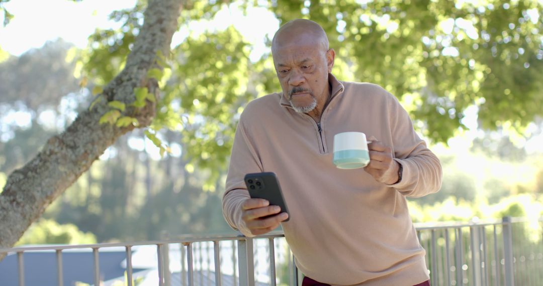 Senior Man Enjoying Coffee While Using Smartphone Outdoors - Free Images, Stock Photos and Pictures on Pikwizard.com