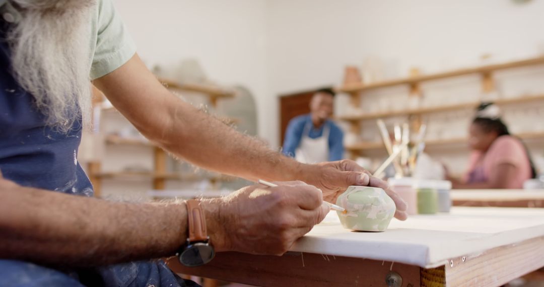 Senior Artisan Painting Ceramic in Pottery Workshop - Free Images, Stock Photos and Pictures on Pikwizard.com