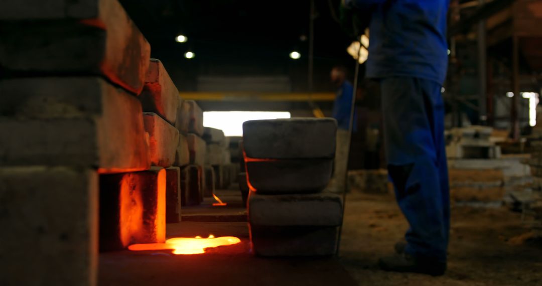 Workers Handling Hot Metal Ingots in Foundry - Free Images, Stock Photos and Pictures on Pikwizard.com