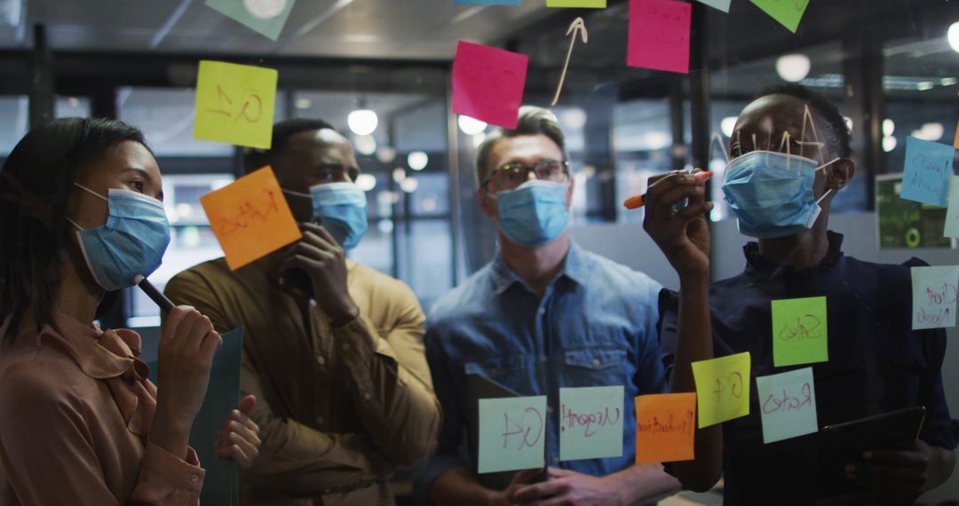 Masked Professionals Collaborating in Office Space