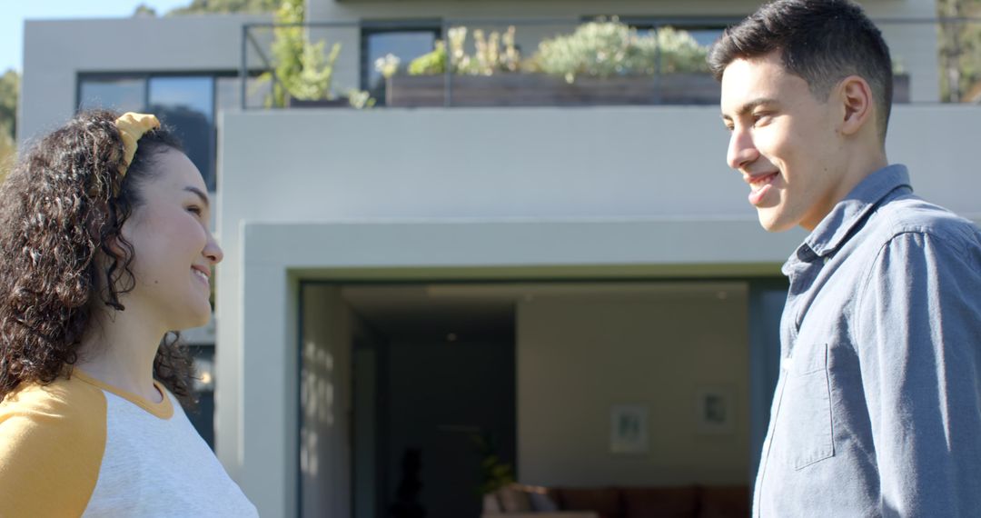 Joyful Couple Conversing in Sunny Modern Suburban Patio Setting