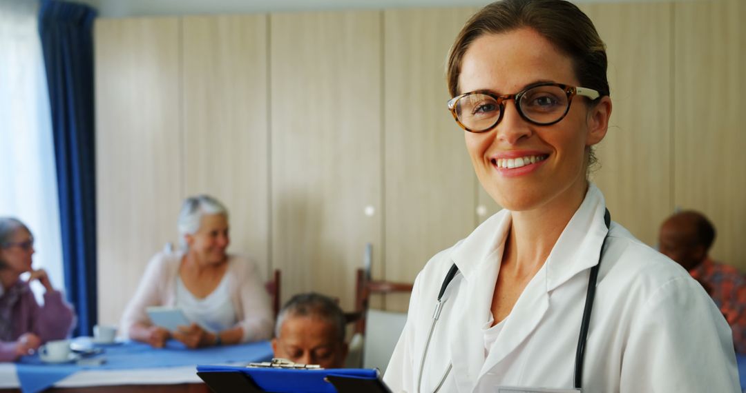 Smiling Female Doctor Interacting with Senior Patients - Free Images, Stock Photos and Pictures on Pikwizard.com