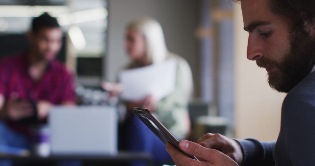 Professional Man Using Smartphone in Modern Office Environment
