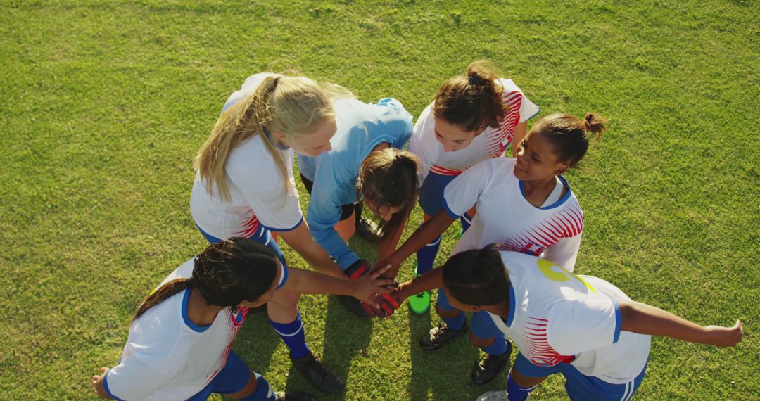 Female Youth Soccer Team Huddling on Soccer Field - Free Images, Stock Photos and Pictures on Pikwizard.com