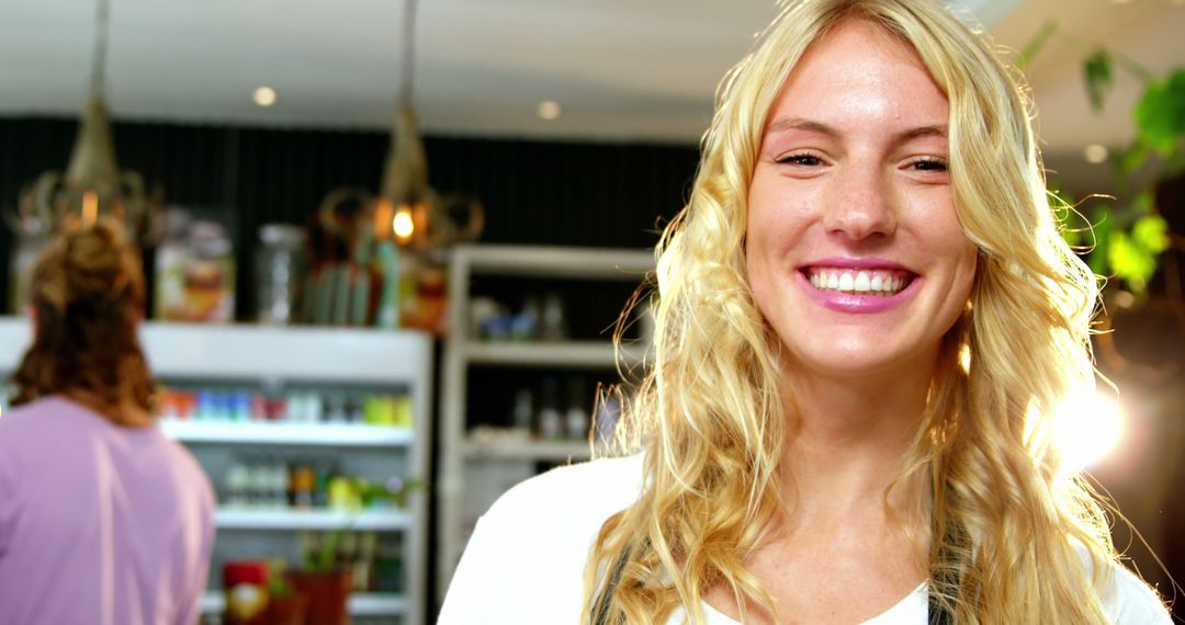 Smiling Blonde Woman Working in Cozy Café Interior - Free Images, Stock Photos and Pictures on Pikwizard.com