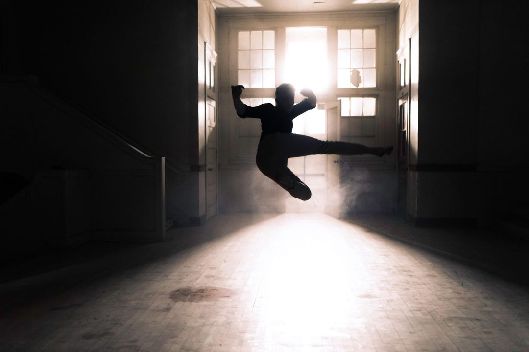 Silhouette of A Person Flying Kick Inside A Room - Free Images, Stock Photos and Pictures on Pikwizard.com