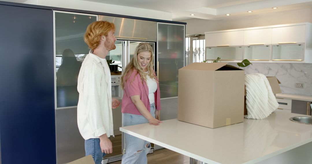 Happy Couple Exploring New Kitchen While Moving In