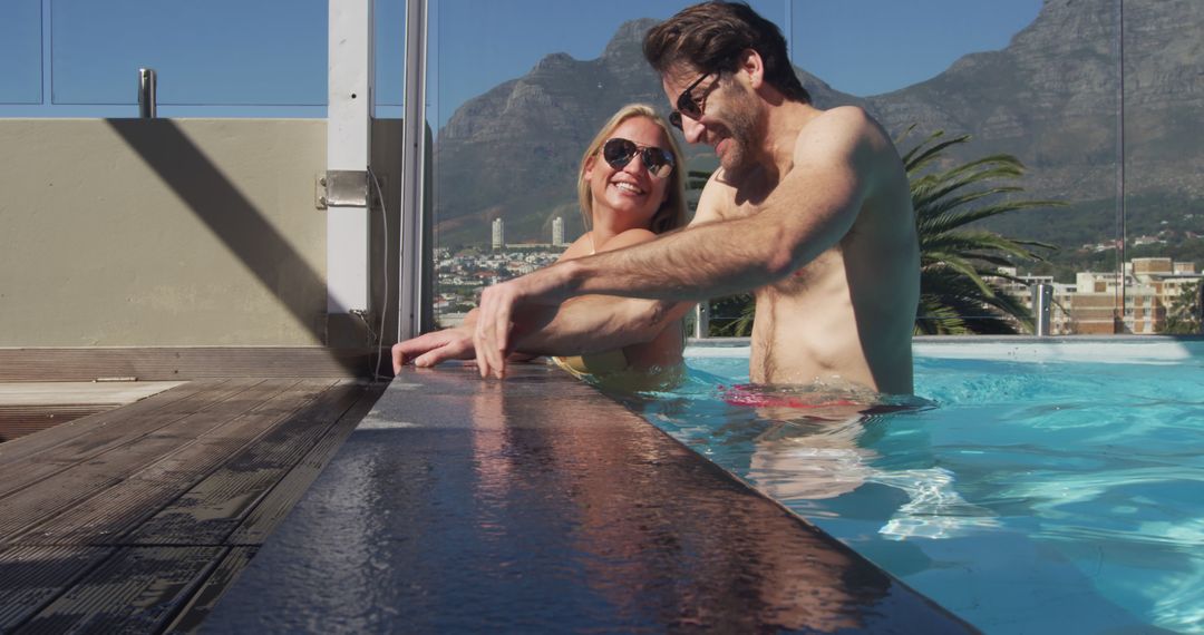 Smiling Couple Enjoying Pool with Scenic Mountain View - Free Images, Stock Photos and Pictures on Pikwizard.com