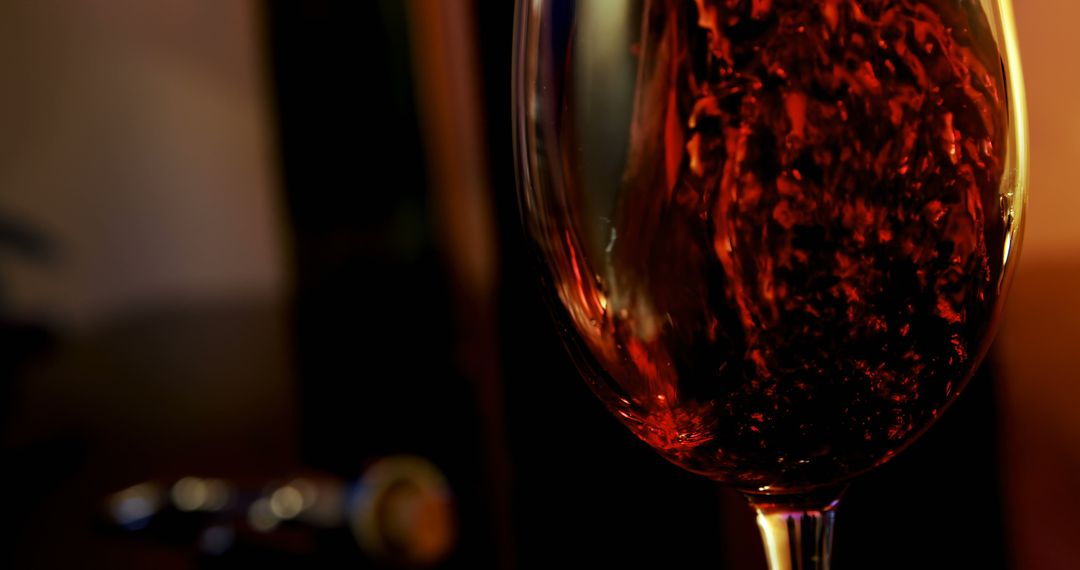 Close-Up of Red Wine Being Poured into Glass in Dimly Lit Ambiance - Free Images, Stock Photos and Pictures on Pikwizard.com