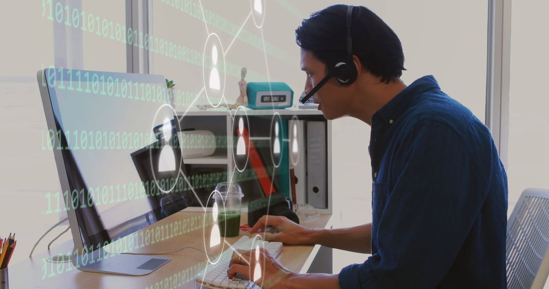 Businessman Using Computer with Data Icons Overlay in Modern Office