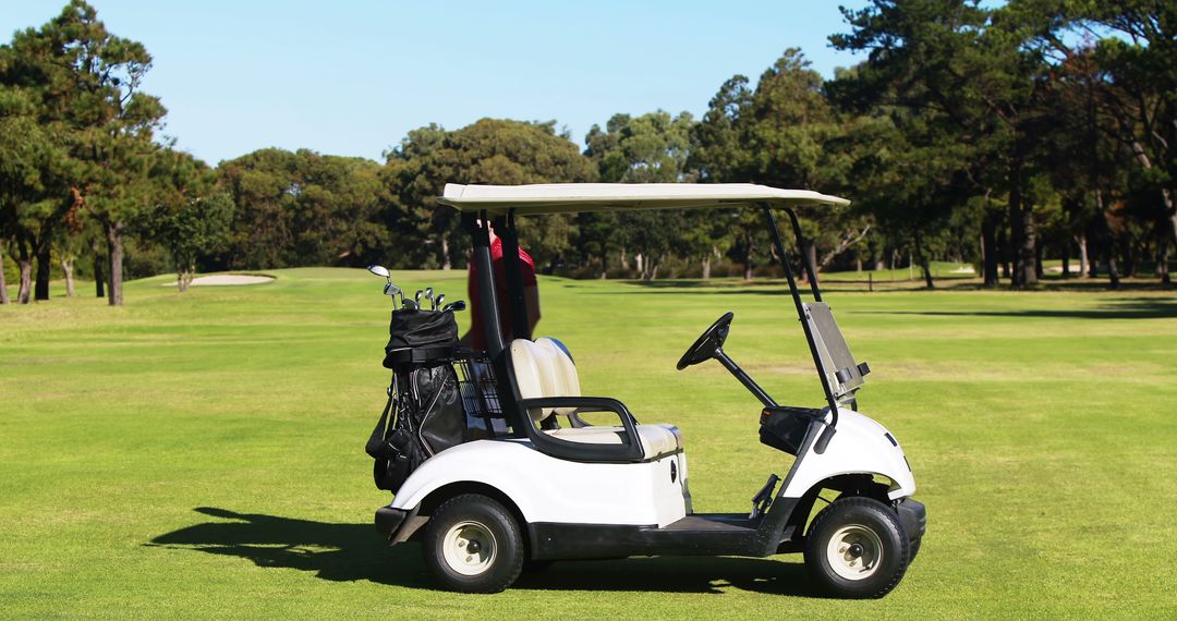 Golf Cart with Clubs Set on Scenic Green Golf Course