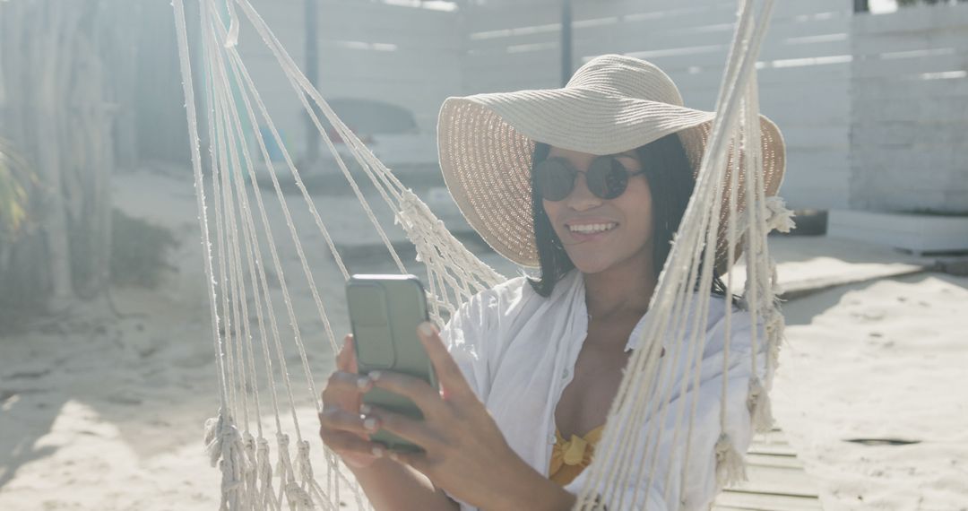 Woman Relaxing in Hammock Taking Selfie at Beach - Free Images, Stock Photos and Pictures on Pikwizard.com