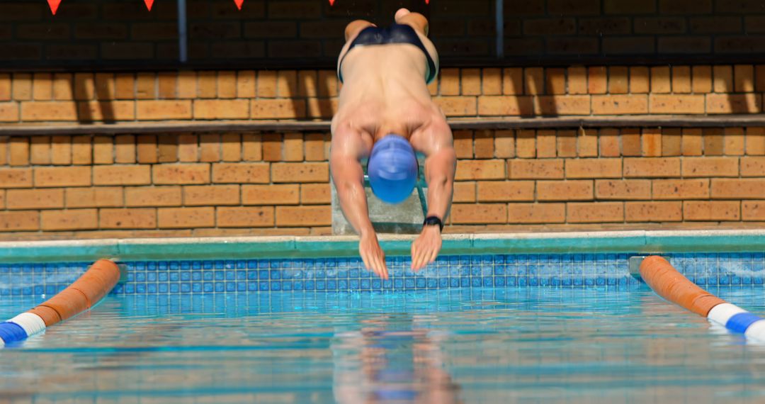 Swimmer Diving Into Pool During Training Session - Free Images, Stock Photos and Pictures on Pikwizard.com