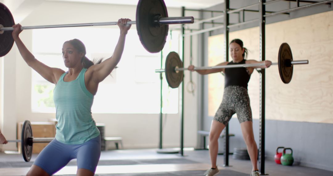 Two Women Weightlifting in Modern Gym - Free Images, Stock Photos and Pictures on Pikwizard.com