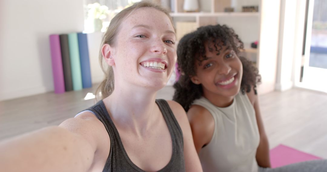 Two Women Smiling After Yoga Workout in Living Room - Free Images, Stock Photos and Pictures on Pikwizard.com