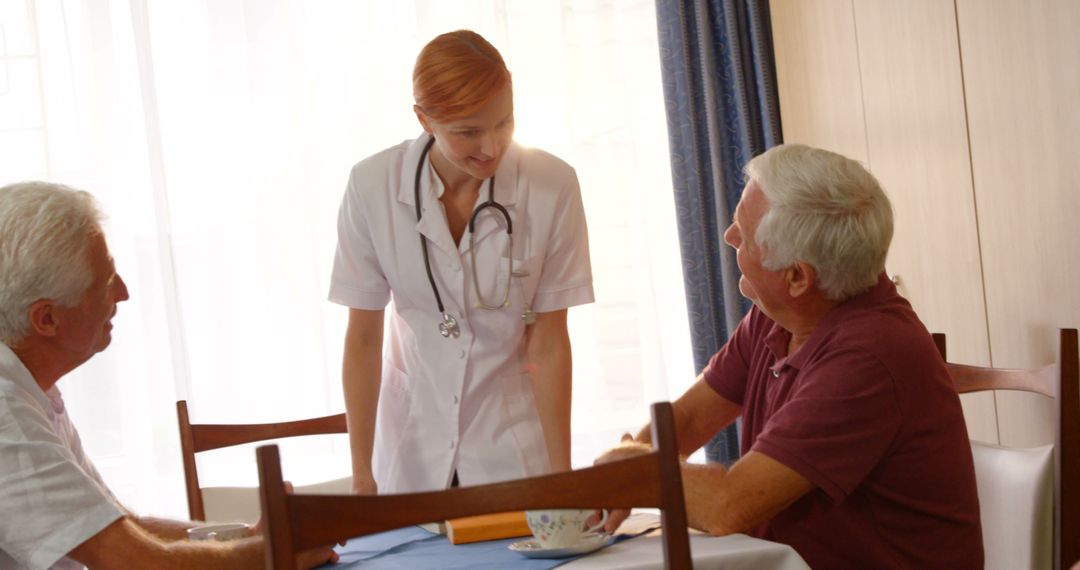 Nurse Engaging with Elderly Men in Nursing Home - Free Images, Stock Photos and Pictures on Pikwizard.com