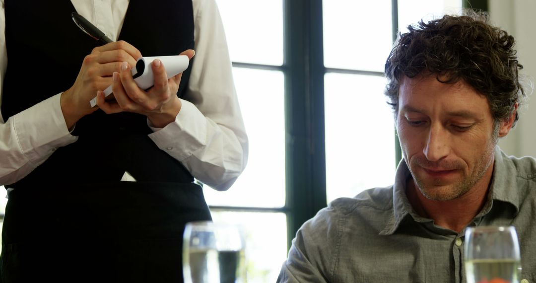 Man Dining in Restaurant Being Served by Waiter - Free Images, Stock Photos and Pictures on Pikwizard.com