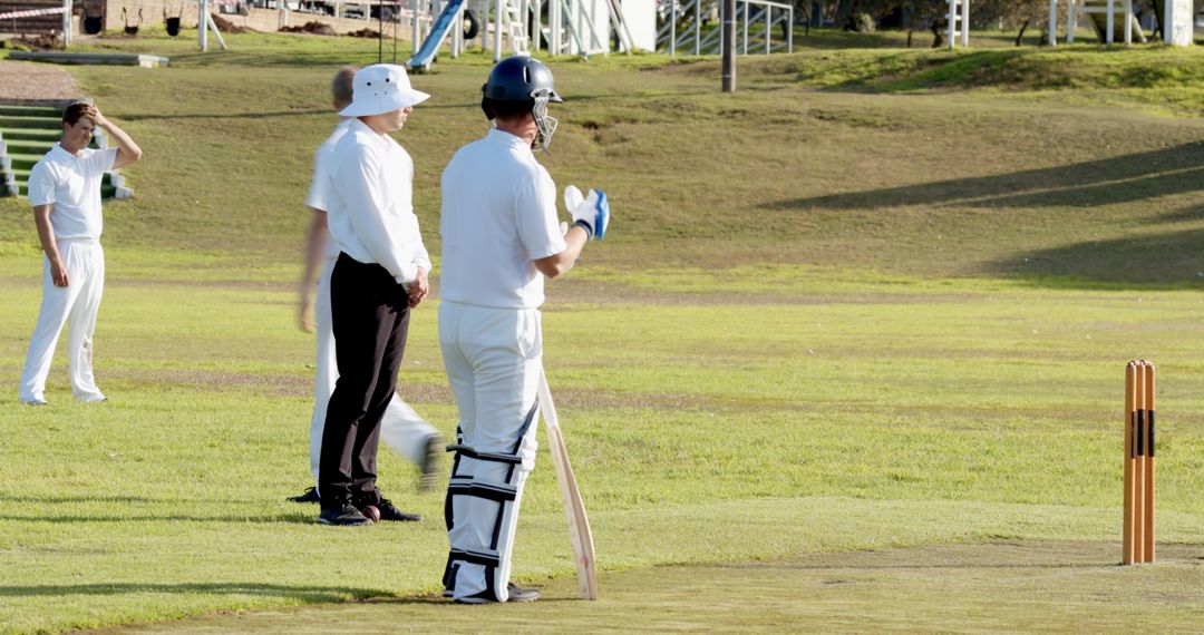 Cricketer Preparing to Bat on Cricket Field with Ultimate Focus