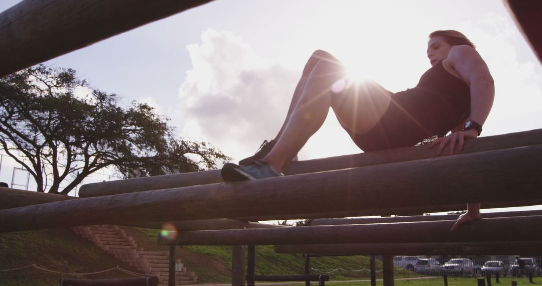 Woman Performing Obstacle Course Training as Sun Sets - Free Images, Stock Photos and Pictures on Pikwizard.com