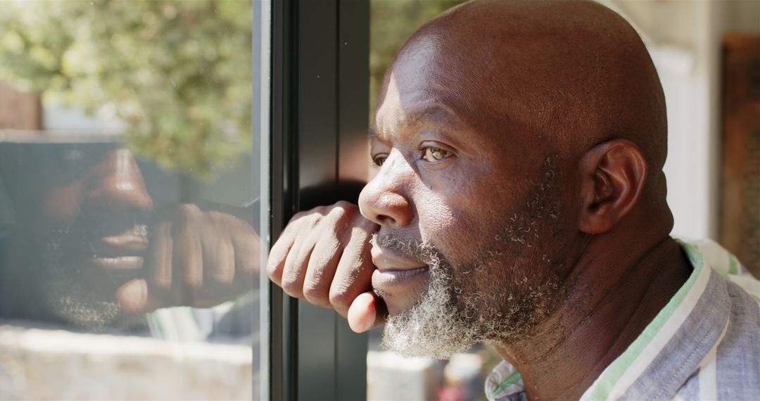 Pensive Man Looking Out Window Reflecting on Life