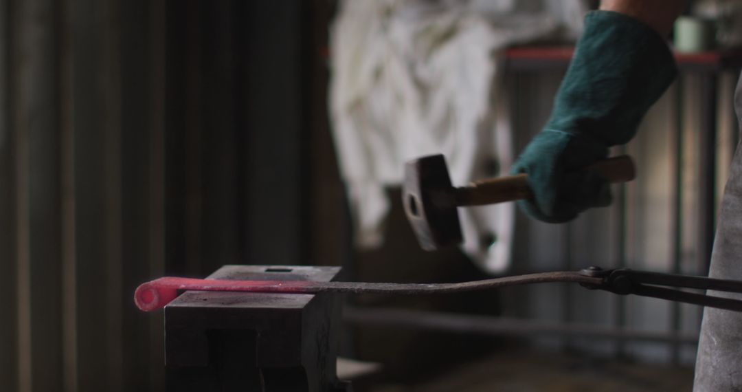 Blacksmith Hammering Hot Metal on Anvil in Forge Workshop
