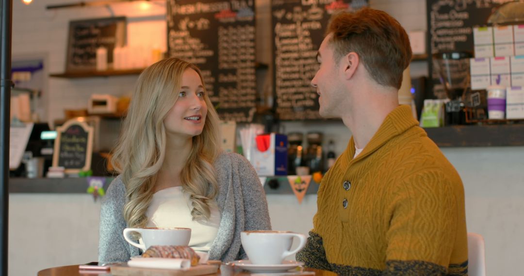 Young Romantic Couple Interacting Happily in Modern Cafe Environment - Free Images, Stock Photos and Pictures on Pikwizard.com