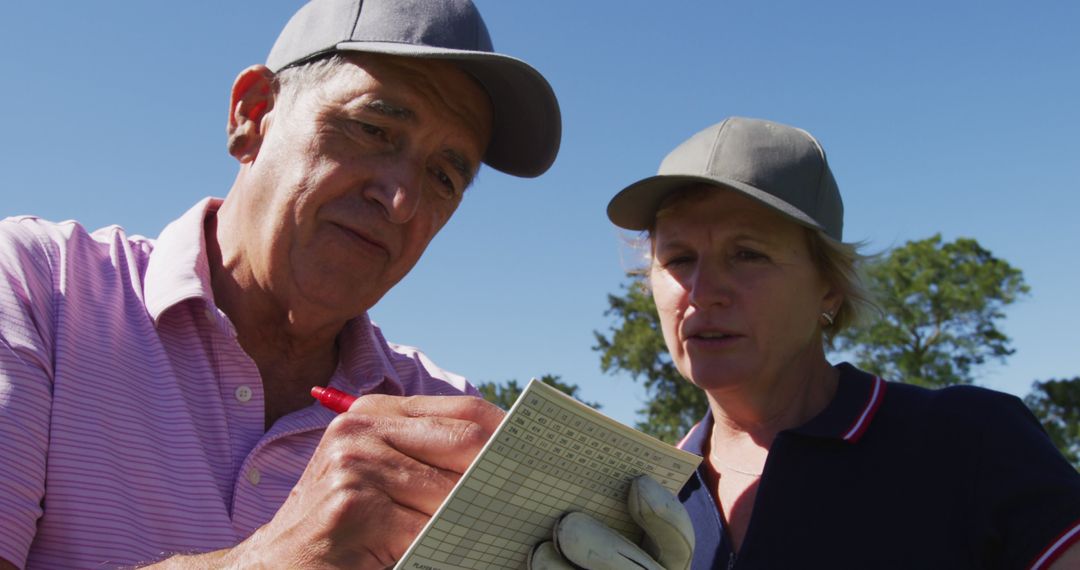 Senior Couple Engaging in Golf Score Keeping - Free Images, Stock Photos and Pictures on Pikwizard.com