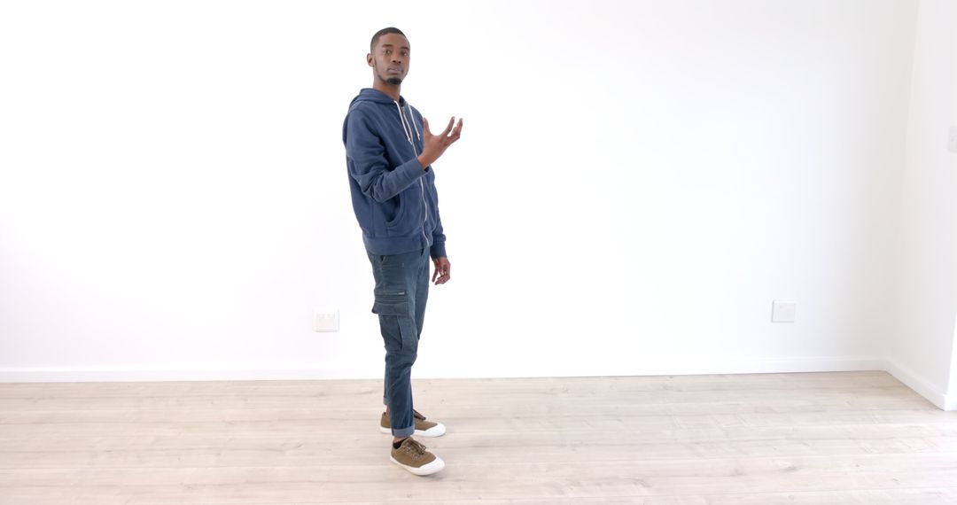 Young Man Practicing Dance in Bright Empty Room
