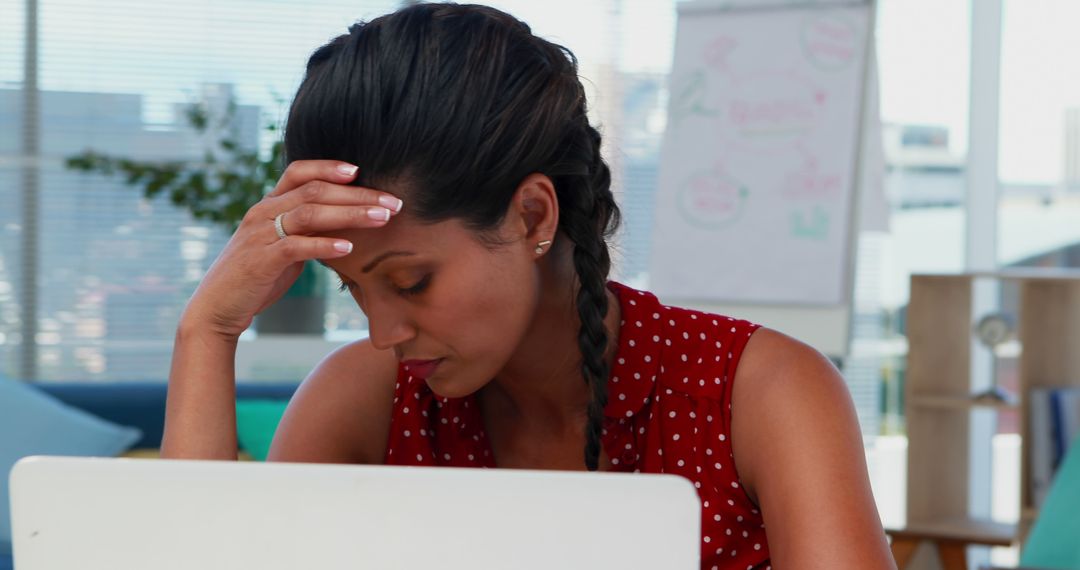 African American woman looks stressed at her office desk - Free Images, Stock Photos and Pictures on Pikwizard.com