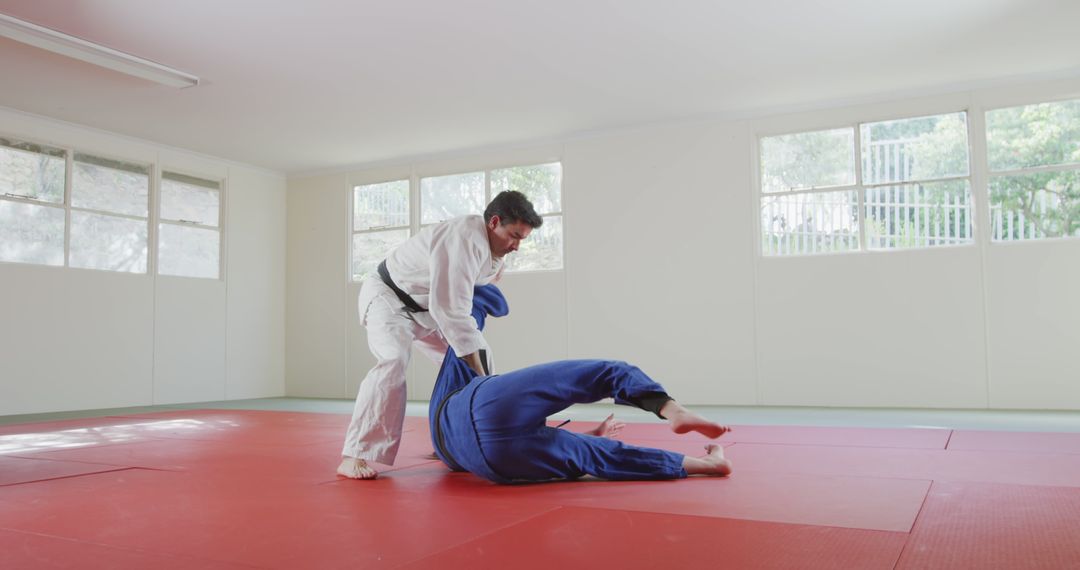 Judo Practice in Training Room with Mats and Window View - Free Images, Stock Photos and Pictures on Pikwizard.com