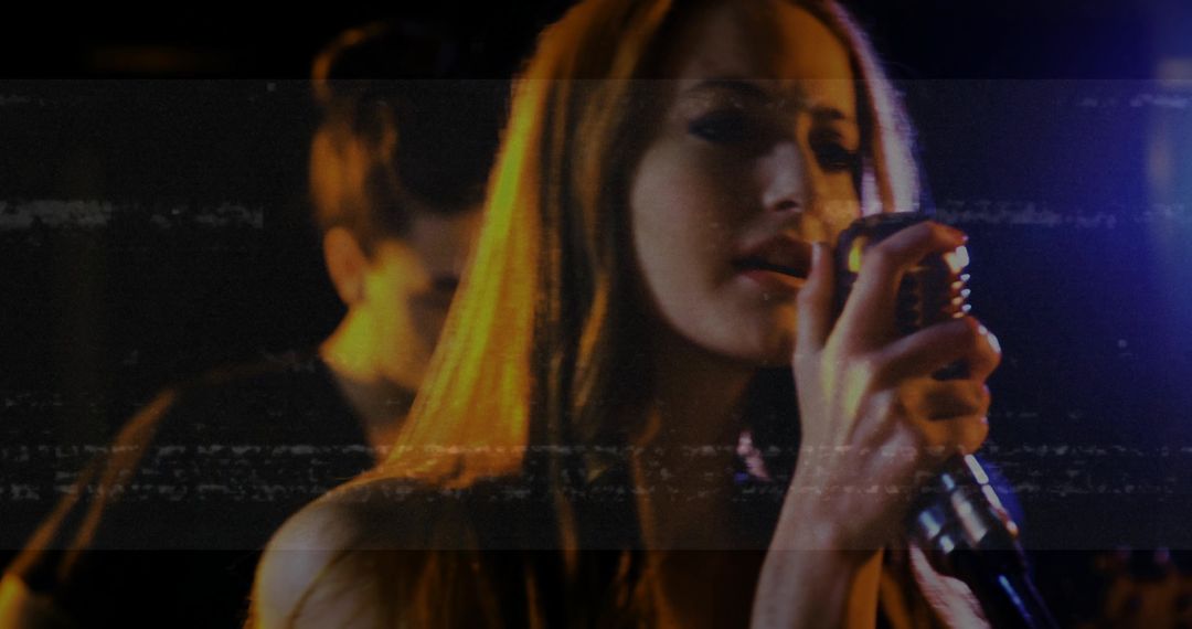 Singer Performing on Stage With Band and Vintage Microphone