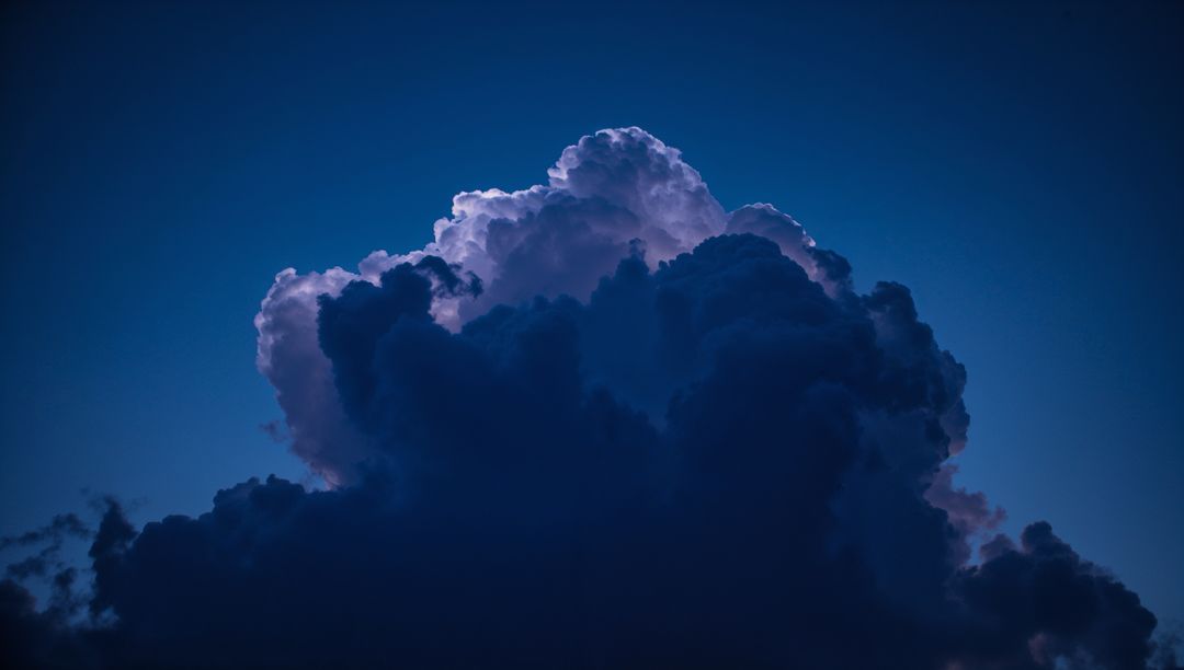 Majestic Cumulonimbus Cloud Illuminated in Dark Sky