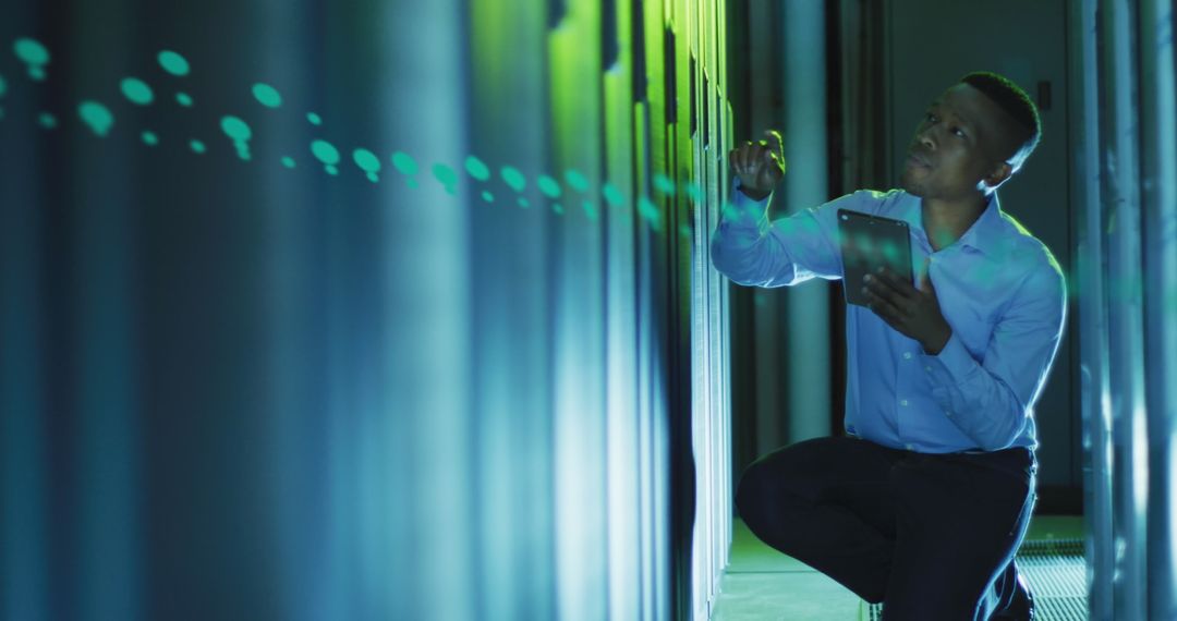 Technician Monitoring Server Racks in Data Center