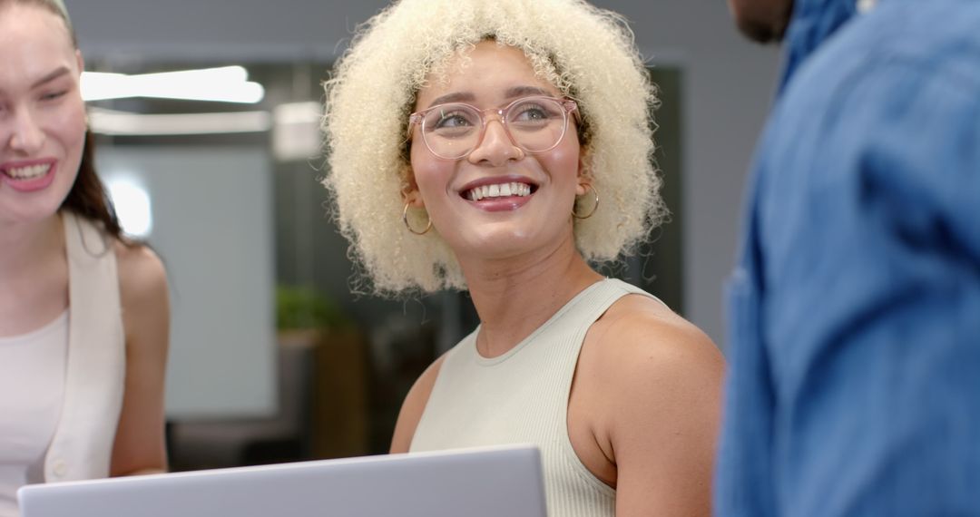 Diverse Colleagues Collaborating on Technology Project in Office