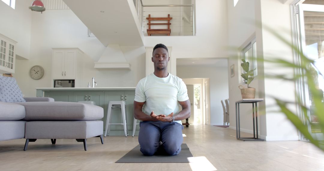 Meditating African American Man in Modern Home Interior - Free Images, Stock Photos and Pictures on Pikwizard.com