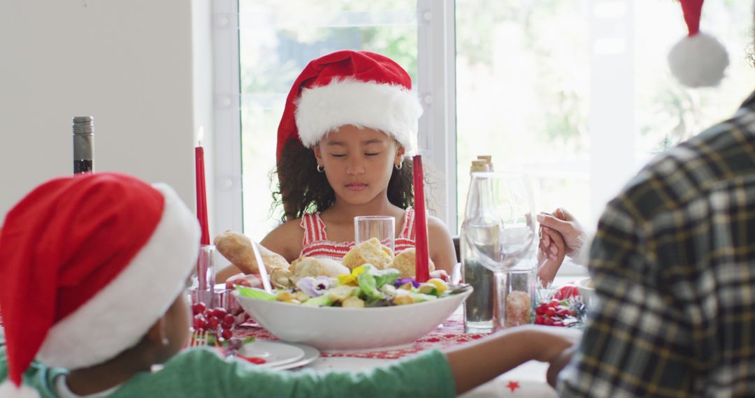 Children Celebrating Christmas Dinner with Santa Hats - Free Images, Stock Photos and Pictures on Pikwizard.com