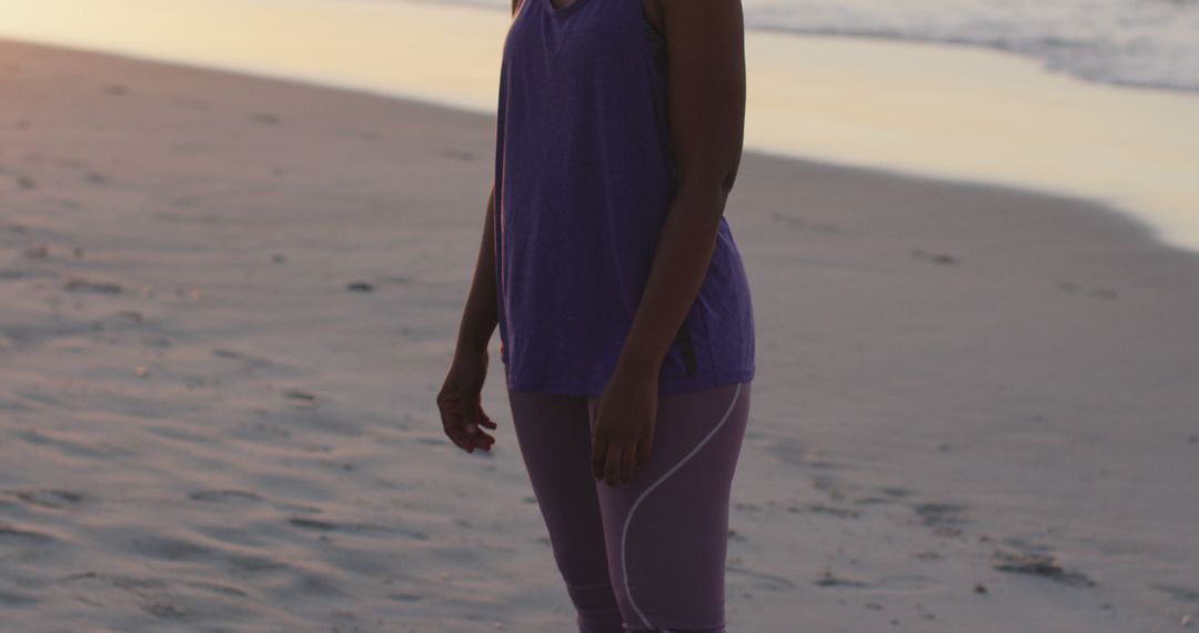 Woman Standing on Sandy Beach During Sunset - Free Images, Stock Photos and Pictures on Pikwizard.com