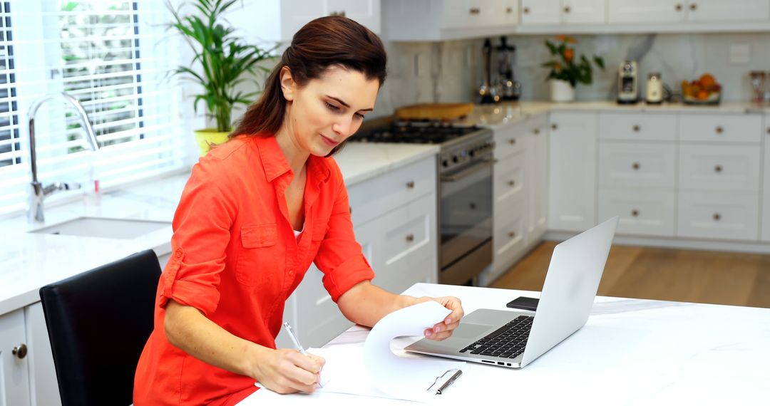 Caucasian Woman Working Remotely at Home in Modern Kitchen - Free Images, Stock Photos and Pictures on Pikwizard.com