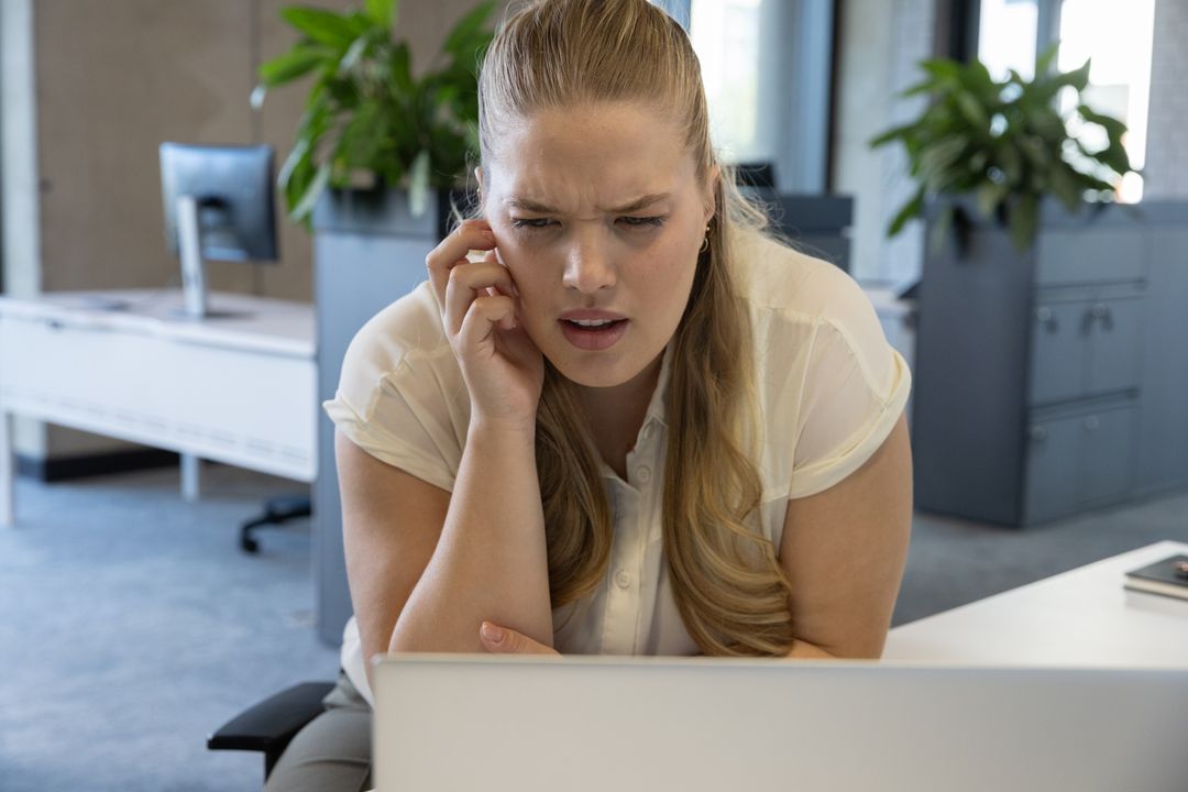 Businesswoman Engaged in Serious Work Call in Open Plan Office