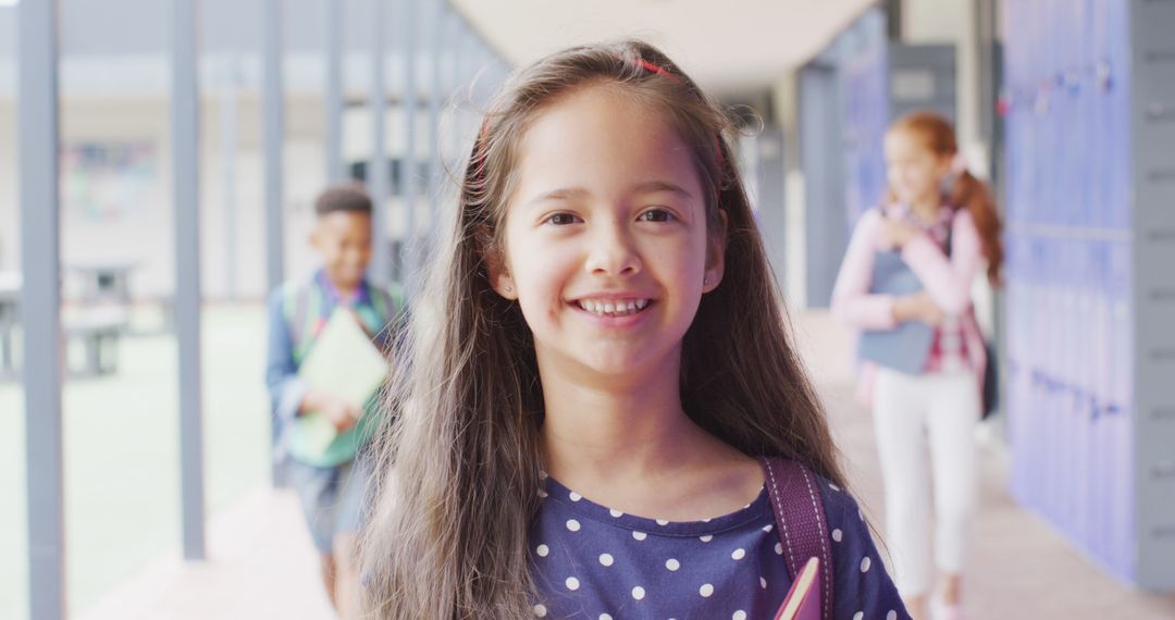 Cheerful Schoolgirl in Corridor with Classmates