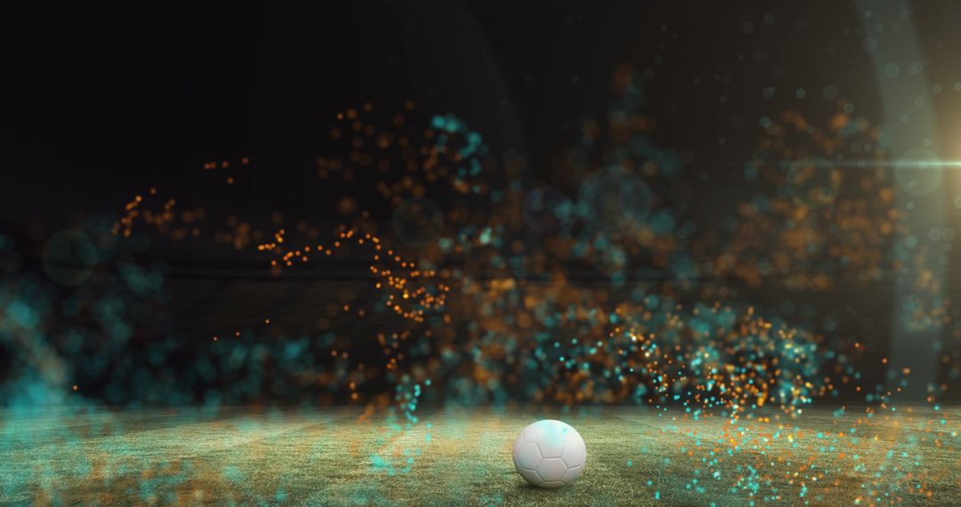 Vibrant Particles Float Over Football on Pitch at Night