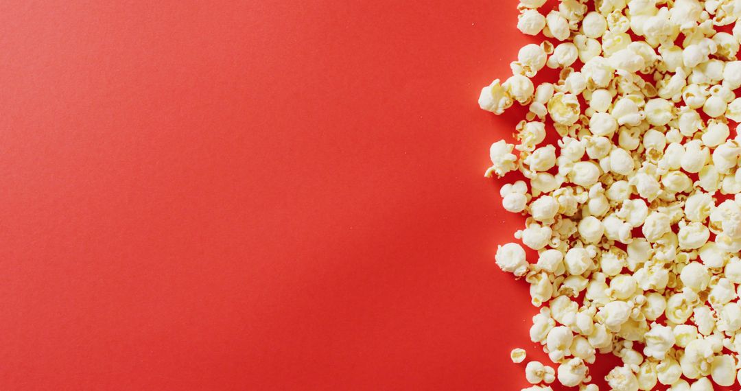 Popcorn on Vibrant Red Background with Copy Space