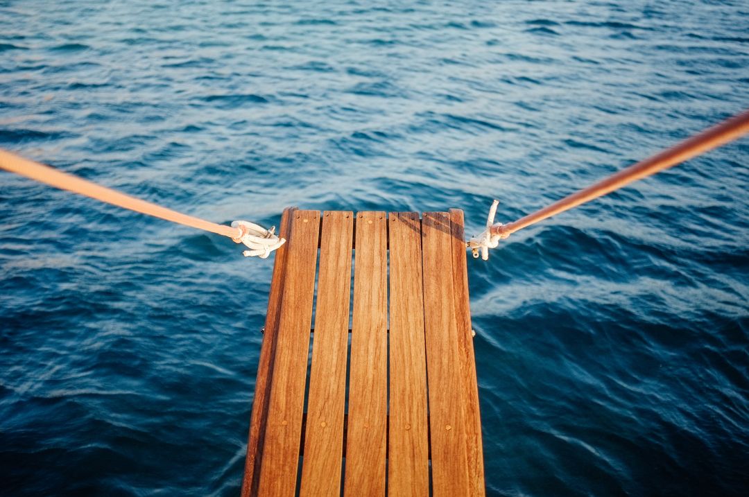 Wooden Dock Extending Over Blue Ocean - Free Images, Stock Photos and Pictures on Pikwizard.com