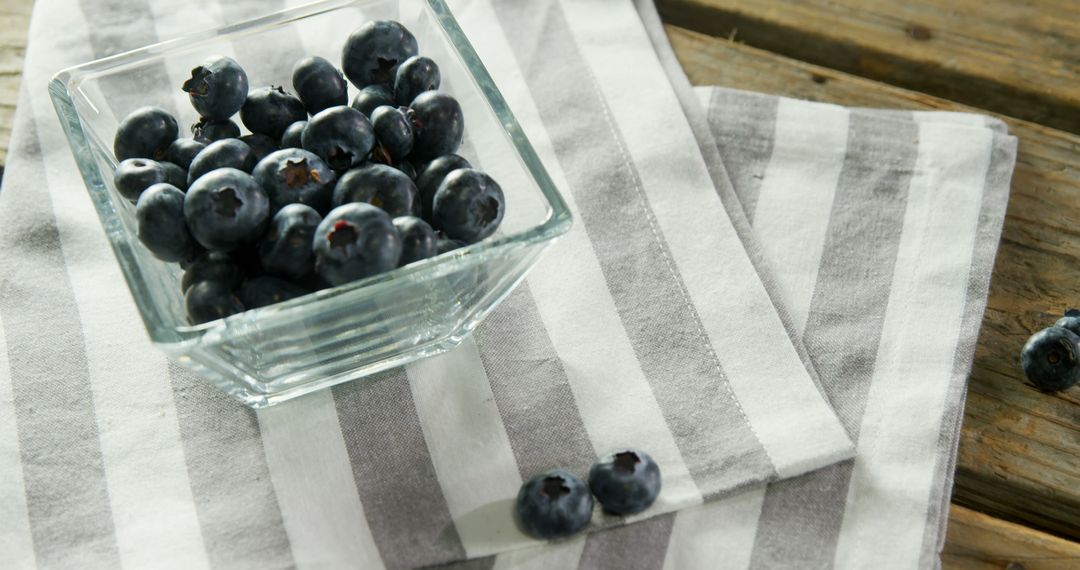 Fresh Blueberries in Glass Dish on Striped Cloth - Free Images, Stock Photos and Pictures on Pikwizard.com