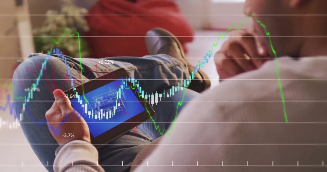 Businessman Analyzing Financial Data on Tablet with Graphs