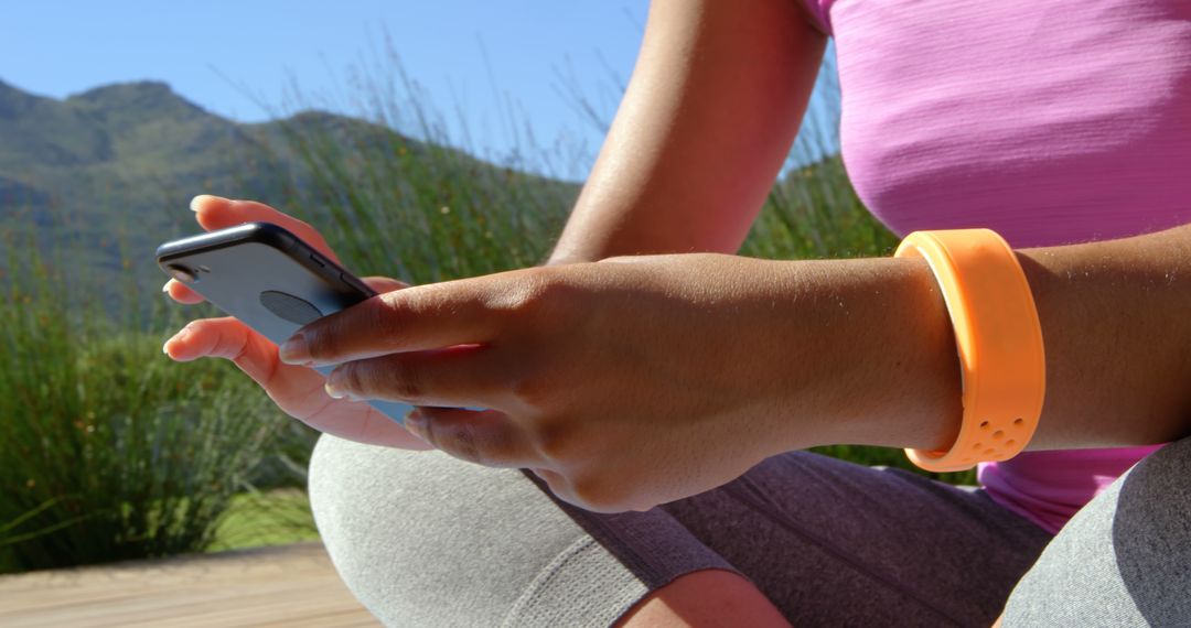 Woman Using Smartphone Outdoors with Fitness Tracker - Free Images, Stock Photos and Pictures on Pikwizard.com