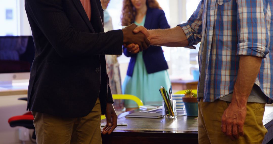 Business Professionals Shaking Hands in Office Environment
